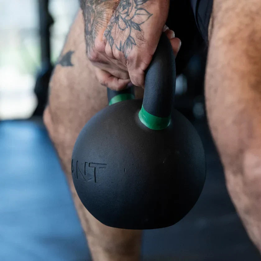 Man holding a kettlebell doing a swing exercise